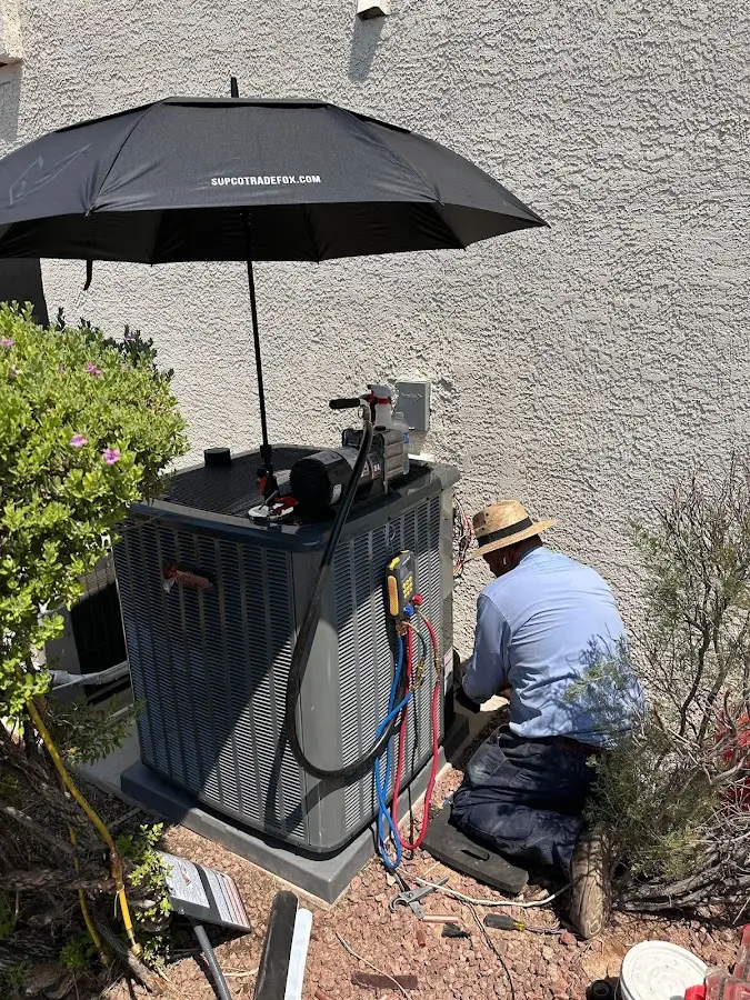 HVAC technician performing outdoor AC maintenance in Milwaukie